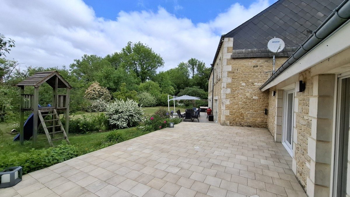 Tuin achter terras met speeltoestel in